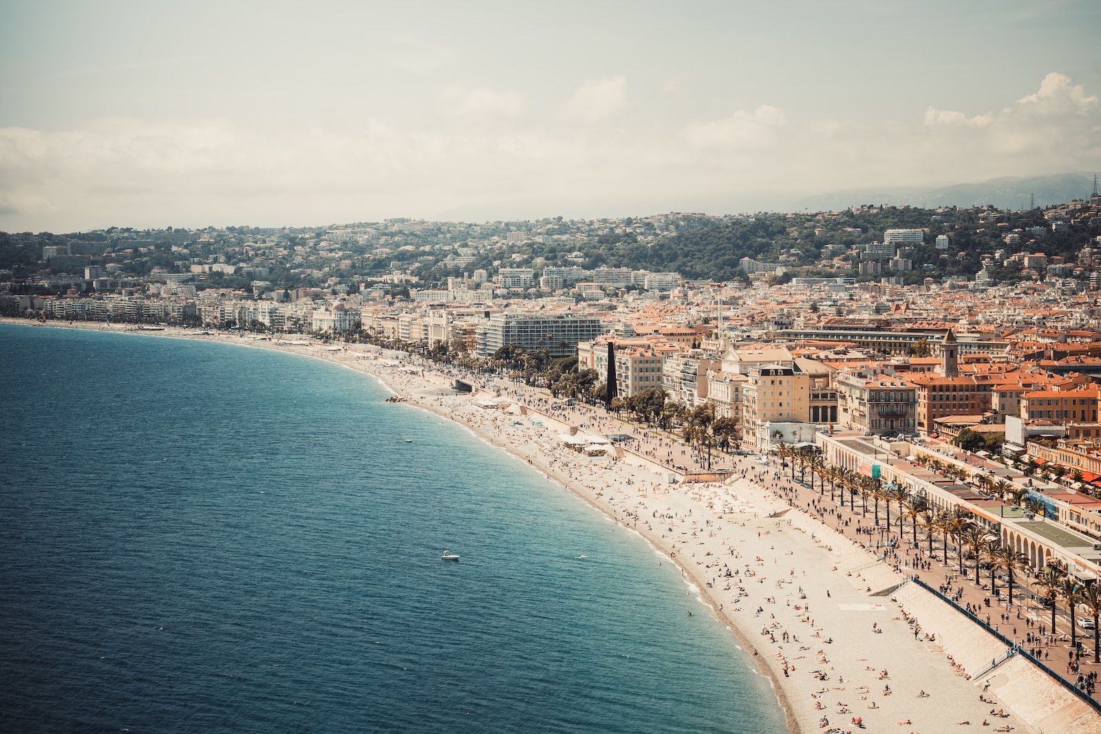 an aerial view of a beach with a city in the background